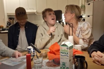 Glada personer runt ett köksbord